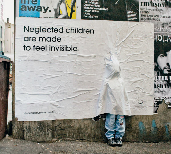 Giant white poster covering a life sized mannequin of a child; advert reads: Neglected children are made to feel invisible
